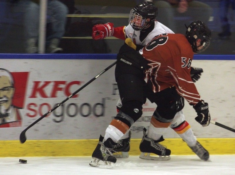 Westlock Midget Warrior Adam Hardinge tries to slip past a bodycheck during the club’s Sunday afternoon 4-3 win over the Redwater Rush. The victory leaves the squad with a