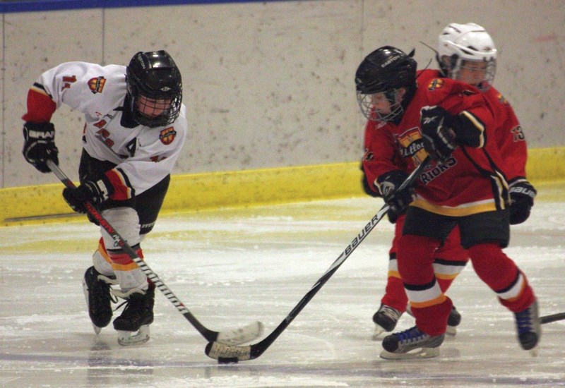 Westlock Atom 2B player Reid Casavant and Atom 2A player Peyton Petryshen go for the puck during a home game on Saturday at the Westlock Rotary Spirit Centre.