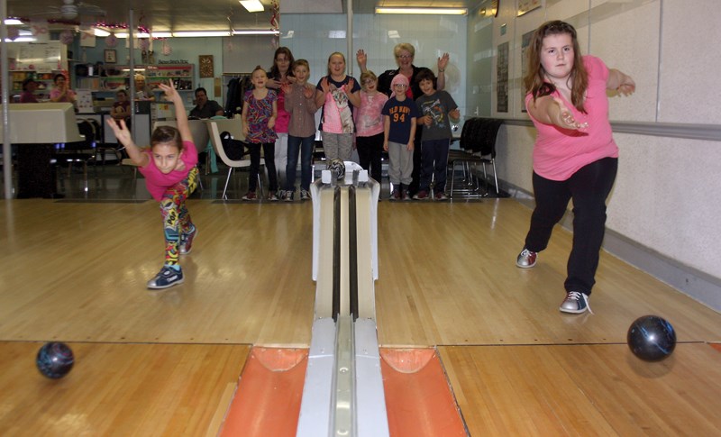 Kaitlyn Menzies (left), 9, and Paige Pirnak, 10, were thinking pink at Westlock Bowl last Saturday afternoon during the Youth Bowler&#8217;s Bowl for Cancer tournament.