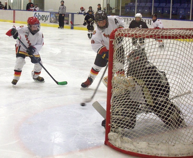 Westlock Atom Warriors Ryker MacPherson (left) and Shawn St. Arnaud worked together to get one past the Onoway Eagles goalie during the Warriors’ 13-1 provincial playoffs