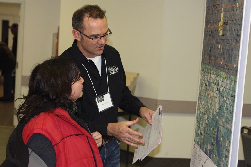 Alberta PowerLine representative Ward Nicholson chats with Sharon Jorawsky about the proposed Fort McMurray West 500 kV Transmission Project during an open house last