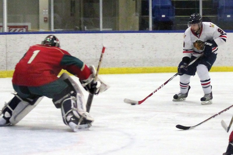 Westlock Warrior Gord Bell fires on the Devon goalie during a blistering first period that saw him score one of the Warriors four goals. The team went on to win the game 9-4