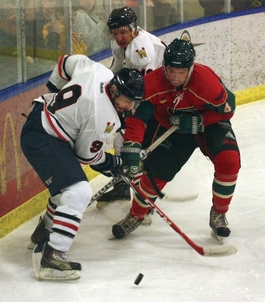 Westlock Senior Warriors’ forward Gord Bell has his eyes on the puck during Saturday’s 5-2 win over the Whitecourt Wild.