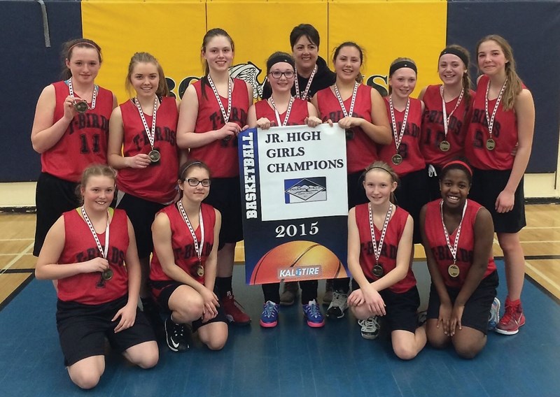 The R.F. Staples junior high girls team pose with their divisional banner. In the back row are Mary Bokenfohr, Rachelle Zadunayski, Brooke Stewart, Latitia Kenyon, coach