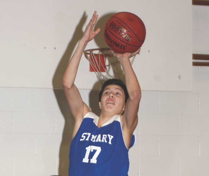 St. Mary Shark Shannon Corbett goes for a two-pointer during their Friday 75-40 win over St. Francis Assisi.