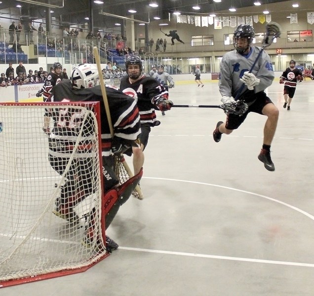 Kyle McCoy springs into action has he shoots on goal during Friday night&#8217;s junior lacrosse pre-season game. McCoy picked up a goal and an assist during the club&#8217;s 