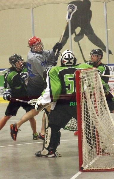 Westlock Rock&#8217;s Colman Herrick fights his way past the Lloydminster Extreme defence during the club&#8217;s April 25 season-opening 10-3 win at the Rotary Spirit Centre.