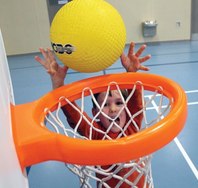 Kage Carson enjoys all the activities Parent Link’s playgroup has to offer, including a kid sized basketball hoop. The playgroup is held in the field house at the Spirit