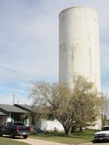 The Westlock water tower sits adjacent to Sherry Laun’s property on 106 Avenue. Recent rain and high winds have cause chunks from the outside of the tower to fall off onto