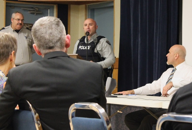 Westlock Elementary School principal Pierre Ouimet looks on as Barrhead area SRO and RCMP Const. Robert Heinz and Sgt. Bob Dodds address a meeting on the issue of full-time