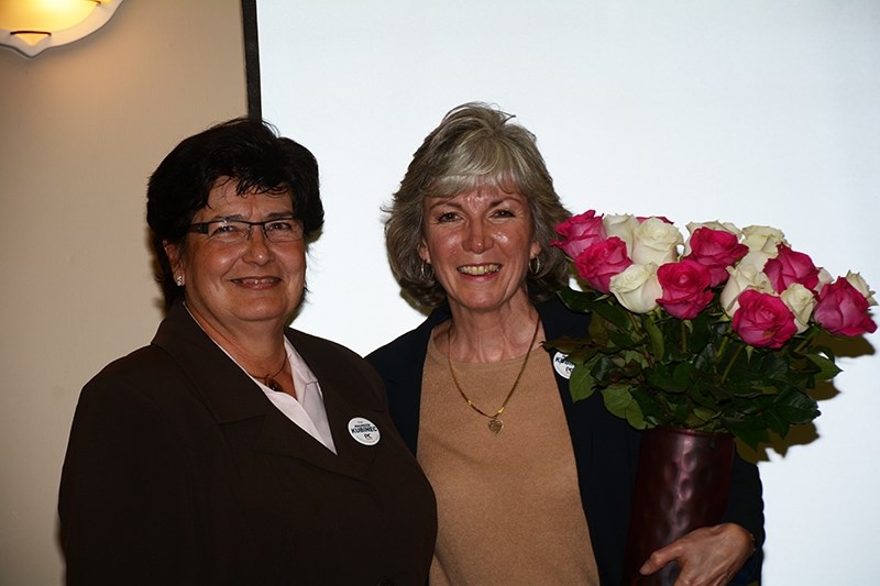 During a private function at the Westlock Inn on election night, former MLA Maureen Kubinec accepts a bouquet of flowers from Geri Savage, her chief financial officer for her 