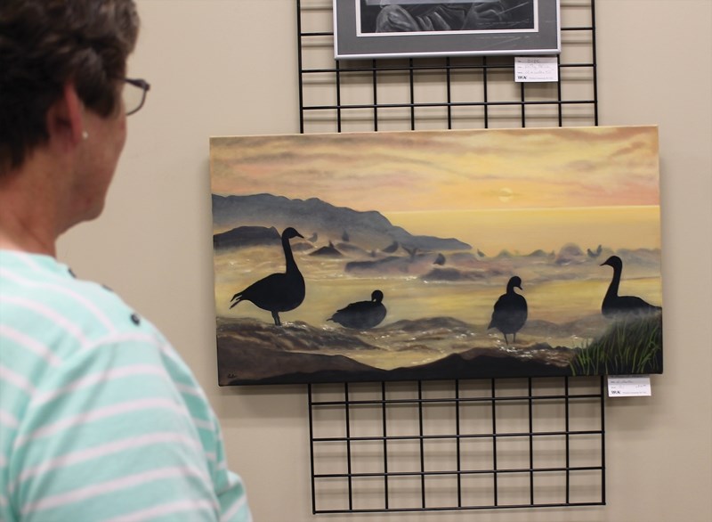 Westlock Art Club life member Marlene Byvank takes a gander at some of the artwork on show during club’s spring exhibition at the Spirit Centre May 8.