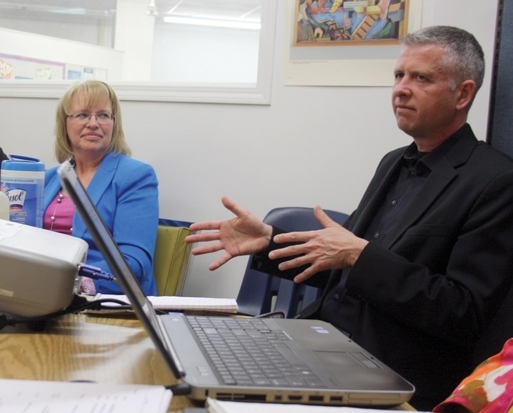 R.F. Staples School principal David Garbutt talks about the Westlock Outreach program while trustee Annette Bokenfohr looks on during the Pembina Hills school board meeting