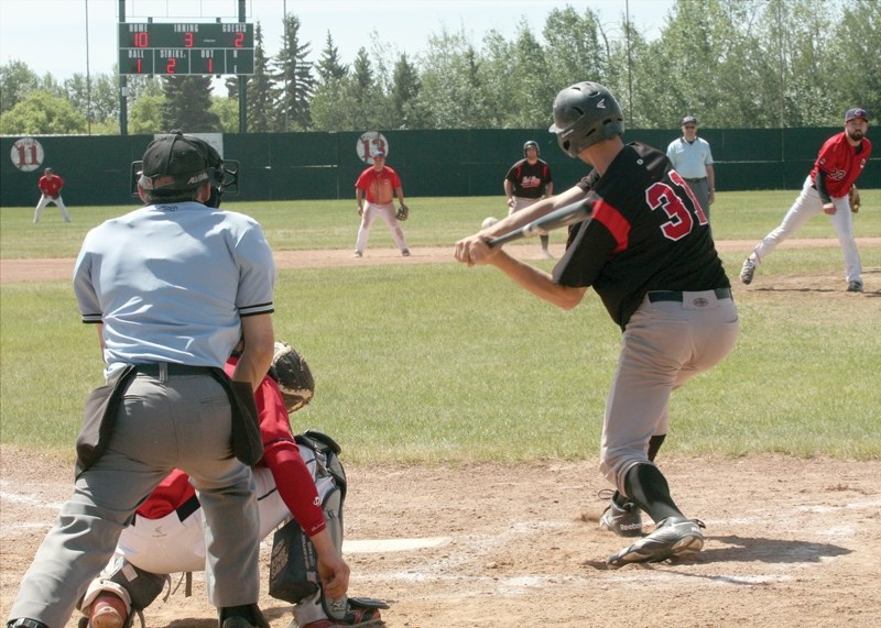 Curtis Burlet makes contact with a pitch during the Lions’ home tournament, the John Golonowski Invitational, on June 7 at Keller Field. The Red Lions handily defeated the