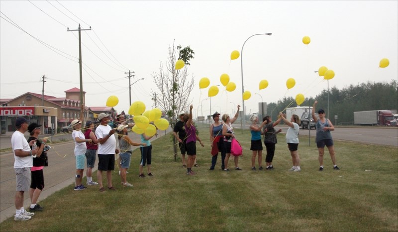 Walk participants let go of balloons in memory of loved ones lost to suicide at the July 11 event in support of the Mental Health Foundation.
