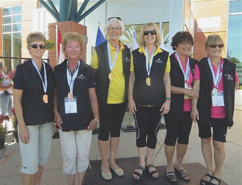 Vivian Oko, of Westlock, and Rosa Semenchuk of Sturgeon County (centre), show off the gold medals they won in the 65-plus women’s pickleball event. Next to them (right) are