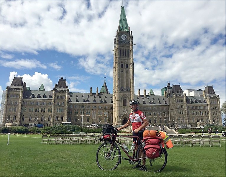 Westlock’s Bryan Carnegie poses in front of Centre Block in Ottawa. The Westlock man has raised close to $12,000 for the Heart and Stroke Foundation on his cross-Canada trip.