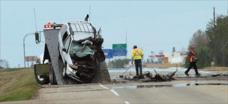 The scene on Highway 2 near the Legal turnoff following an Aug. 17 head-on collision between a minivan and a semi-trailer. The crash claimed the life of the driver of the