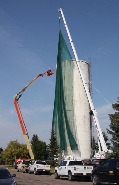 Crews were busy last week erecting a net that will encase the water tower &#8211; it’s hoped the $12,000 net will stop tower debris from pelting a neighbouring home.