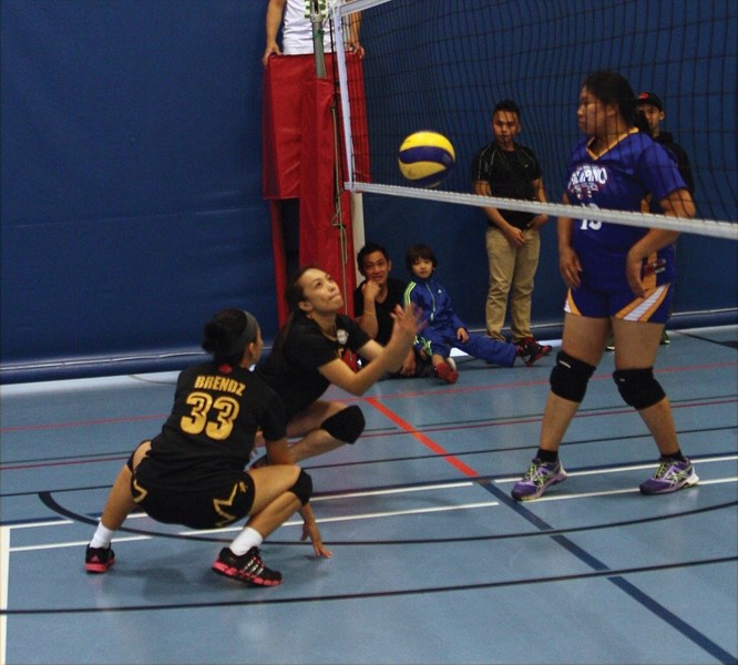 Marfred Bondoc and Brenda Vallega from the Westlock team dive for a ball during a game against the Barrhead on Sept. 5 at the Spirit Centre.