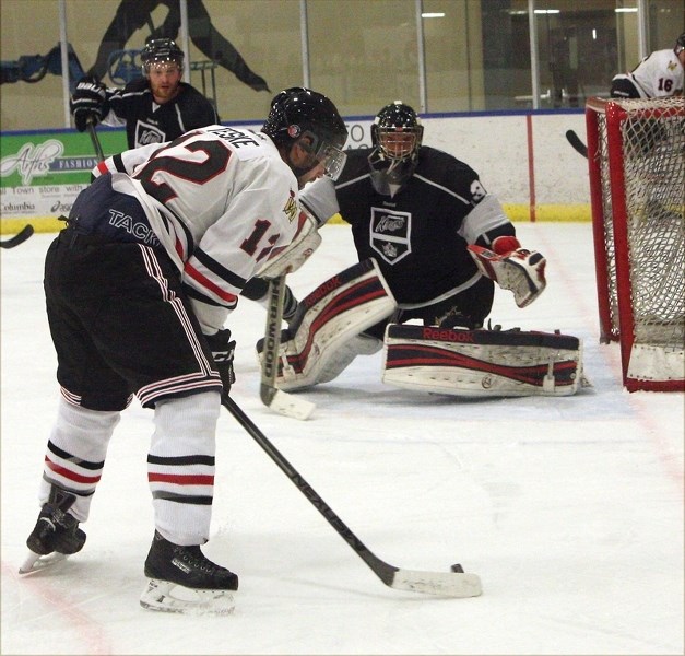 Warrior Derek Teske tries to corral the puck during their 9-1 loss to the Morinville Kings at the Rotary Spirit Centre on Friday. The Warriors rebounded Saturday with a 5-3