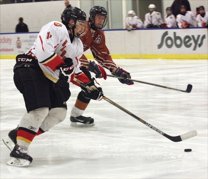 Midget Warriors’ Kestyn Dutchak skates past a Redwater defenceman during a 6-5 Saturday night home loss.