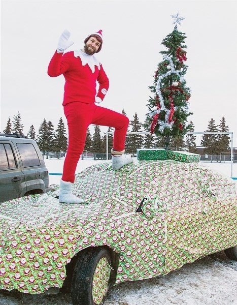 Elf on a car? R.F. Staples teacher Stephen Womack greets students as they arrived at school on Dec. 2.