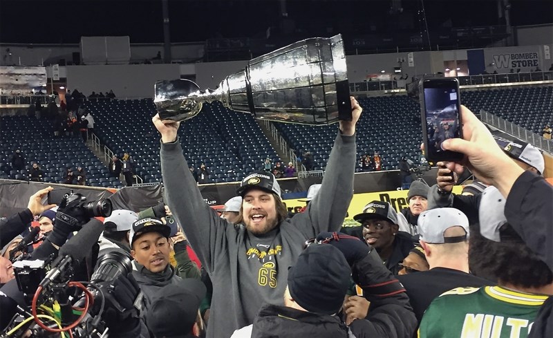 Westlock’s Simeon Rottier, who’s an offensive lineman for the Edmonton Eskimos, lifts the Grey Cup following the club’s 26-20 win over Ottawa in the 103rd Grey Cup played