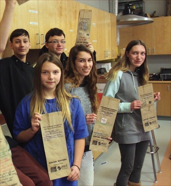 EHS students pose with their hand-decorated liquor bags. Back row, L-R: Blake Hoffman and Dominick Mourao. Front row: Katie Bickford, Jennifer Morozewich and Alysha Byer.