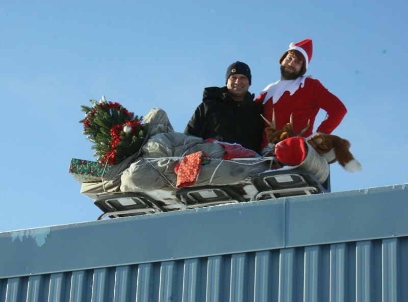 R.F. Staples Elf on the Shelf Cornelius Yukon, AKA Stephen Womack (right), brought joy, cheer and candies to Westlock Elementary School students alongside principal Pierre