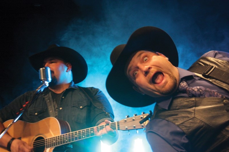Ain’t No Rodeo frontman Darcy Hjelsvold (left) sings while bassist Mike Hittinger strikes a pose at Westlock’s New Year’s Eve Dinner and Dance which served as a kick off to a 