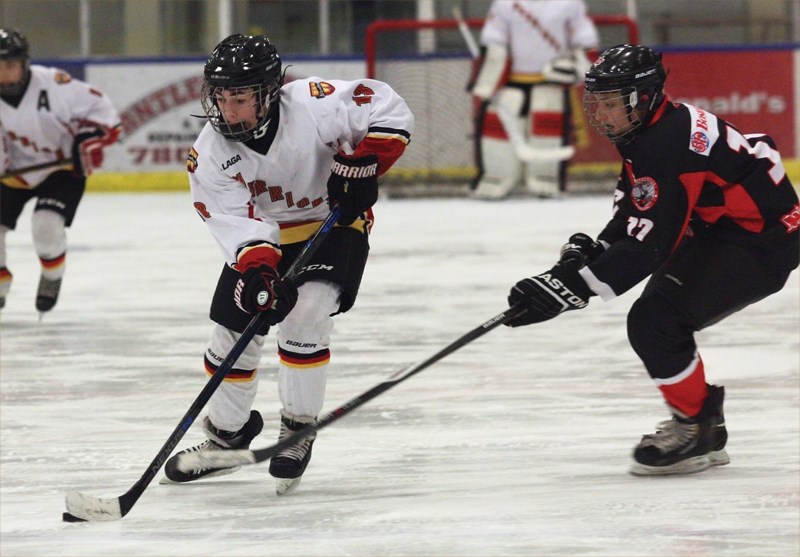 Westlock Tier 3 Bantam Warriors’ Ryan Conquergood steers clear of a stick check during a 4-1 loss to Vegreville at the Rotary Spirit Centre on Saturday, Jan. 23.