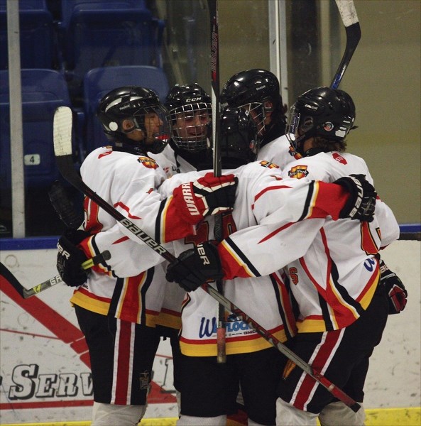 The Midget Warriors celebrate a goal in the third period of their landslide 9-6 comeback win over the CNN Spurs at the Rotary Spirit Centre Jan. 30.