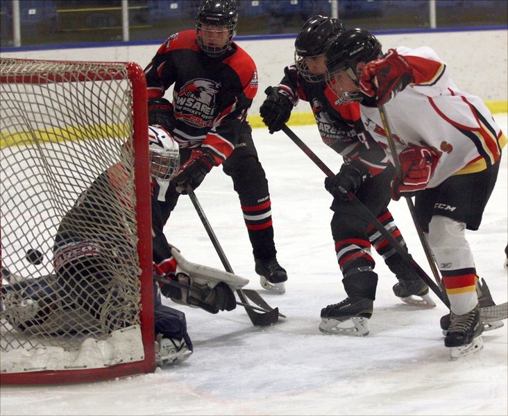 Warriors’ Zaidyn Pipke gets in close to chip away at the New Sarepta Eagles’ goalie during the club’s 8-4 Friday-night win at the Rotary Spirit Centre. The club sits in third 