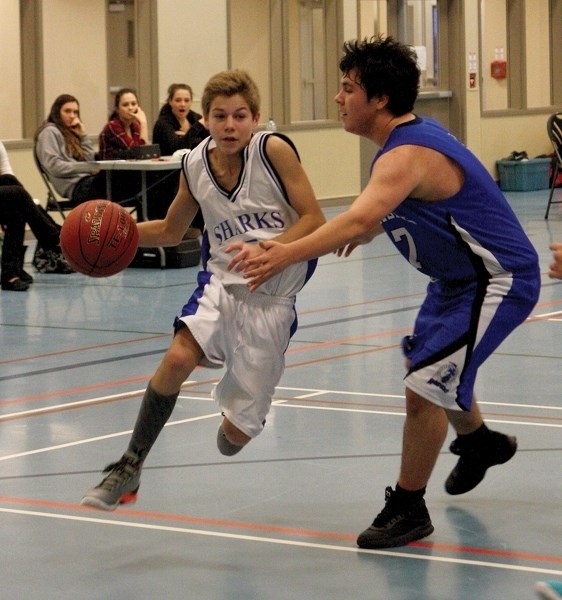 t. Mary Shark Thomas Schwarz drives to the net during round robin play at the W.J. Kallal Memorial Tournament held Feb. 5-6 at the Rotary Spirit Centre. The Sharks lost in