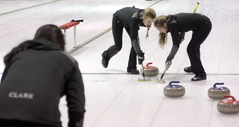 L-R: Skip Emily Clark looks on as Emily Deibert and Gabriella Rocque sweep at the Westlock Curling Club’s annual Mixed Bonspiel on Feb. 13. The Clark rink placed second in the