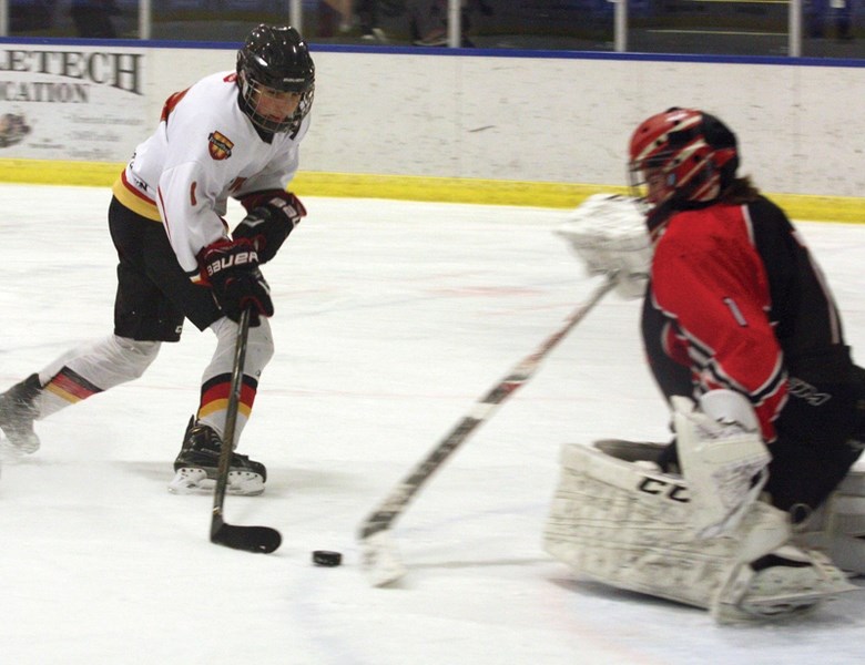 Bantam Warrior Zaidyn Pipke is poke-checked while in on a partial breakaway during Zone 3 provincial playdown action on Monday, Feb. 8. The Warriors lost 5-2 and were