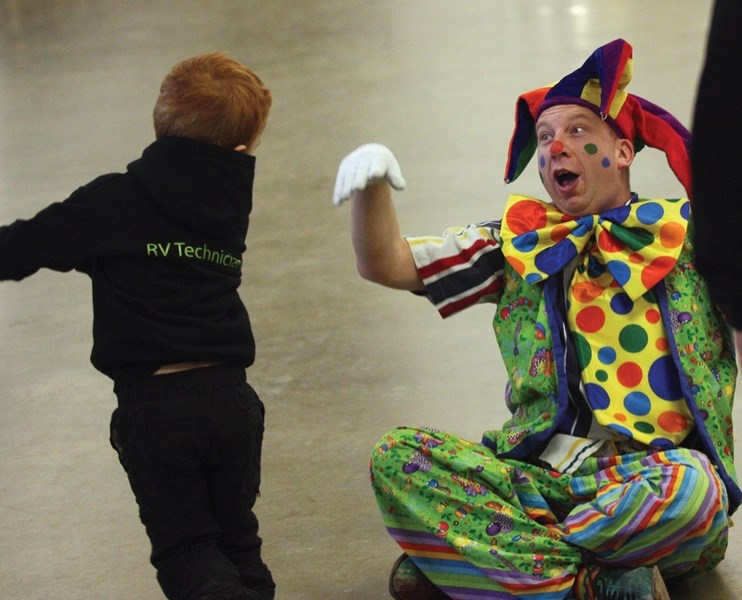 Blake Thomaser high fives Joey the Clown during Family Day activities at the Rotary Spirit Centre Feb. 15.