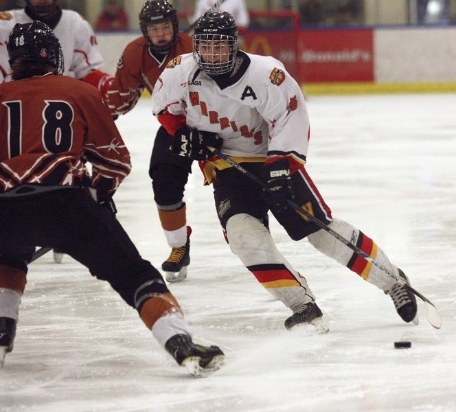 Westlock Midget Warriors’ assistant captain Spencer Blades works his way around a Redwater Rush defender during their 6-4 overtime victory at the Rotary Spirit Centre Feb.