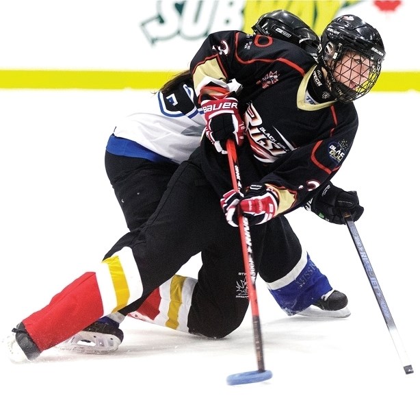Edmonton Black Gold Rush player Marie-Eve Gautier slides past a BC Thunder player the team’s 8-5 victory on Nov. 22 in Edmonton. The Rush will play Edmonton WAM! March 5 at