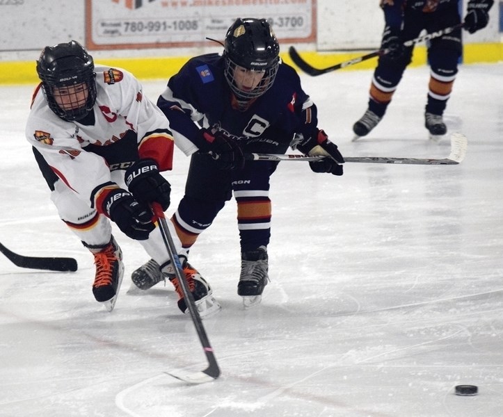 Westlock Pee Wee Warriors’ captain Cole Beaver fights for the puck during the club’s 2-1 March 13 semifinal win over Kitscoty at the provincial