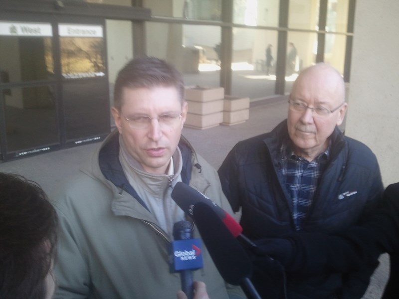 Thorhild County reeve Dan Buryn (left) and councillor Wayne Croswell address the media outside the Edmonton Law Courts building Friday. A Court of Queen’s Bench Justice has