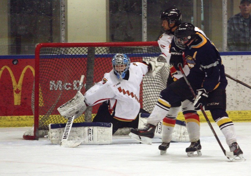 Warriors goalie Tristan Miller bats aside a CNN slapshot during the club’s 8-6 loss to CNN at the Rotary Spirit Centre March 13.