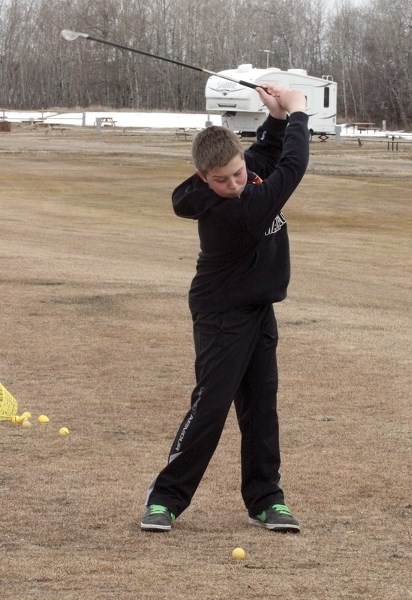 Youngster Reid Casavant tees one up at the Westlock Golf Course driving range on March 31. The rest of the course is set to open by the weekend.
