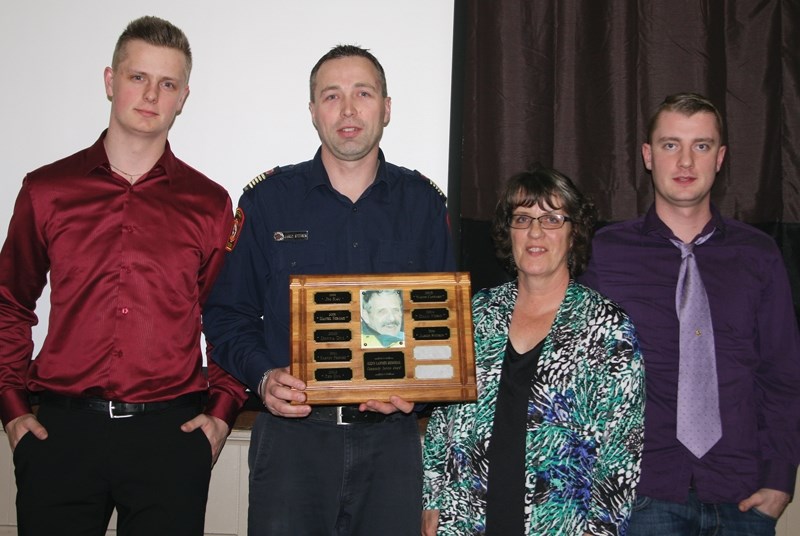 Busby’s Jared Stitsen was presented the Glenn Latimer award Saturday night. Pictured (L-R) Latimer’s grandson William Latimer, Stitsen, Latimer’s daughter Charlene Buist and