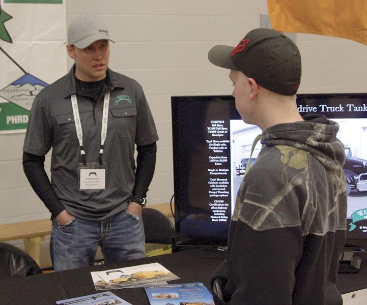 Wabash Manufacturing shop supervisor Jordan Lucas speaks with R.F. Staples Grade 9 student Brayden Bachmier at the R.F. Staples and St. Mary School career fair, held in the
