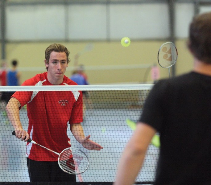 Grade 10 R.F. Staples student Jacob Williston returns a serve during the junior mixed doubles final during the 2016 North Conference Senior High Badminton Tournament at
