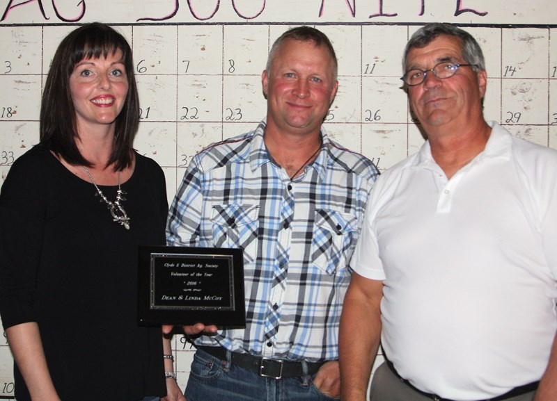 Village of Clyde mayor Doug Nyal (right) presents volunteers of the year Linda and Dean McCoy with their award at Ag 500 Saturday night.