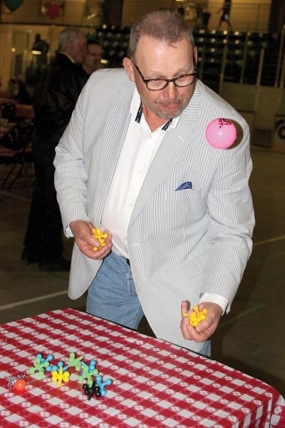 Town of Westlock Mayor Ralph Leriger tries his hand at a game of over-sized jacks on April 28 at the Westlock Rotary Spirit Centre. The town held a supper and games night as