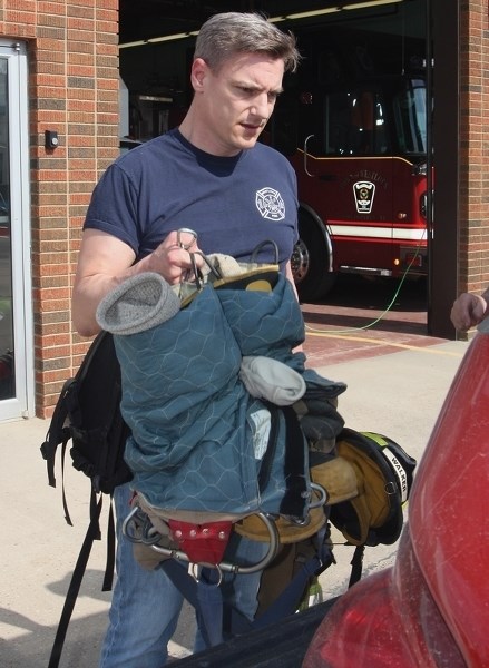 Westlock Fire Department lieutenant Stephen Walker packs his gear before heading to fight the wildfire near Fort McMurray on Wednesday, May 4. Walker was joined by eight